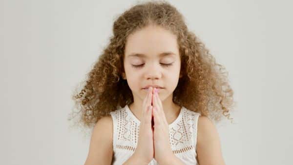 little girl praying and talking to god