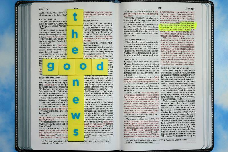 a picture of an open bible with "the good news" in letters