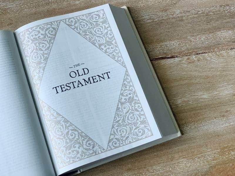 bible laying on a wooden table opened to the old testament which contain prophecies concerning redemption
